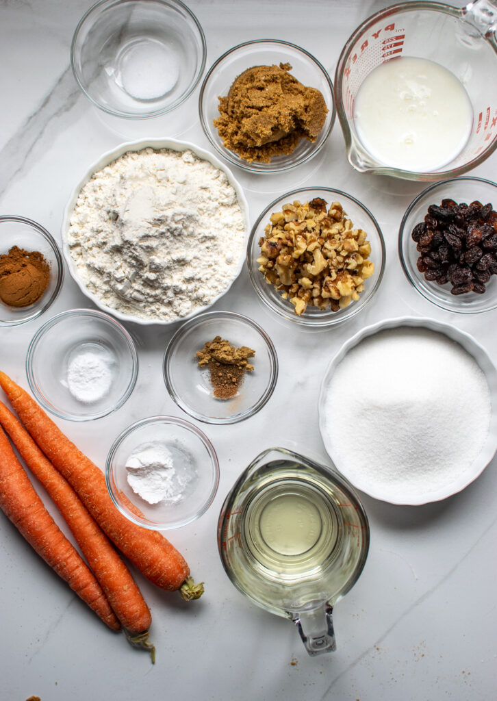 Ingredients for carrot cupcakes including walnuts and raisins.