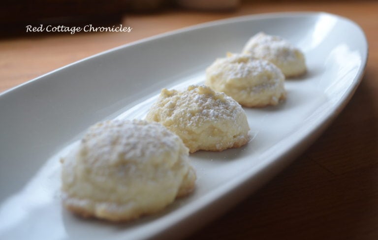 A long plate with 4 lemon shortbread snowball cookies on it.