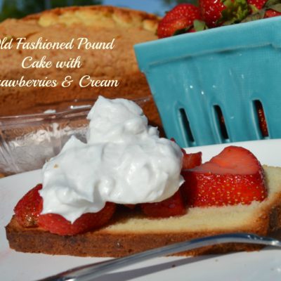 a slice of pound cake topped with strawberries and whipped cream.