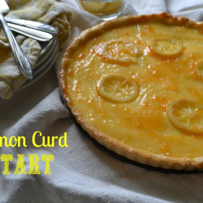 A lemon curd tart topped with fresh lemon slices.