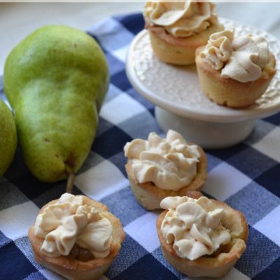 Bite sized pear tartlets on a gingham napkin.