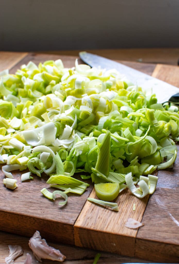 Chopped leeks on a wood cutting board