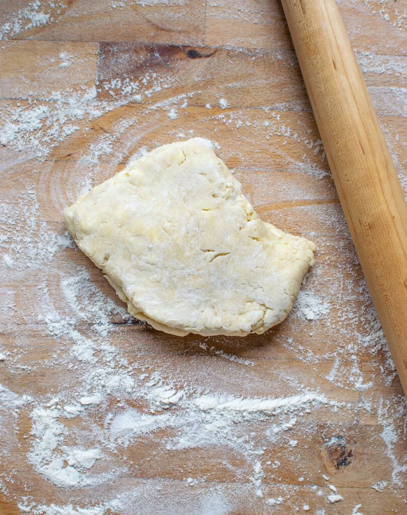 Raw Pie Crust on a floured counter top before it is rolled out.