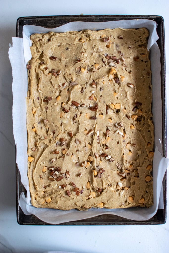 Butter Pecan blondie batter in a nine by thirteen inch pan.