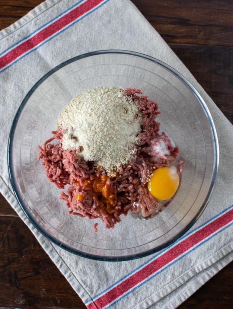 3 steps to making hamberburger patties. Add ingredients to bowl.  Mix well.  Form into patties.