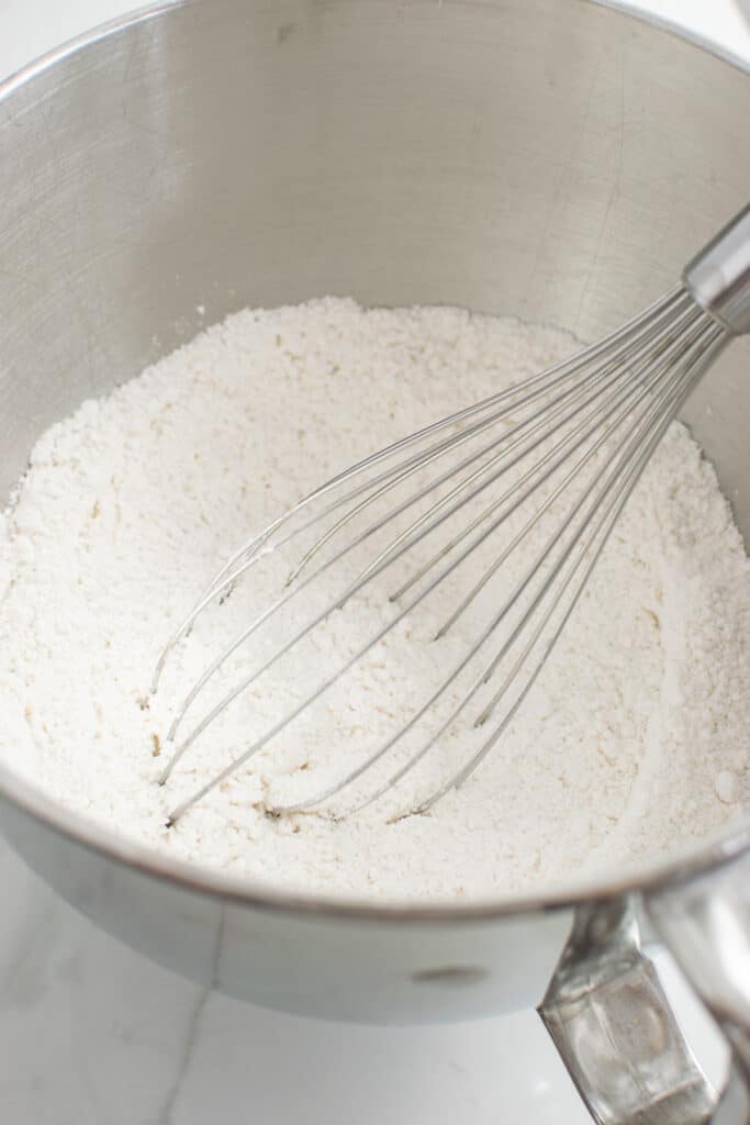 Dry ingredients for sponge cake combined with a whisk.