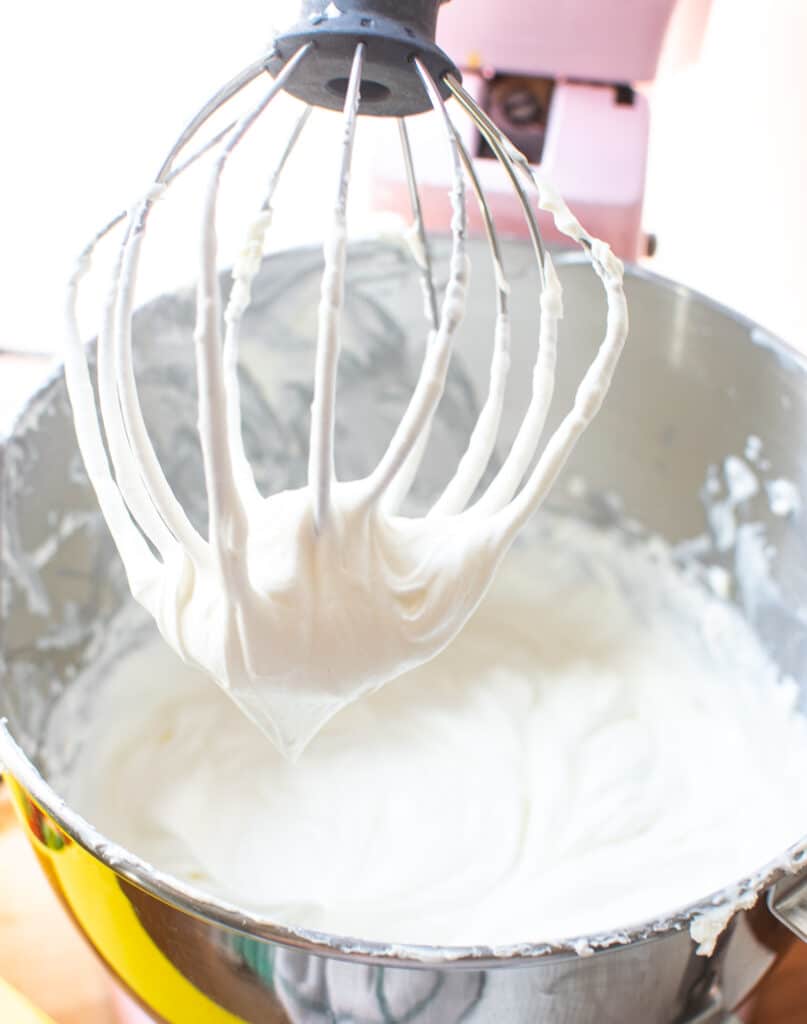 Whipping cream added to beaten cream cheese and icing sugar, and beaten until soft peaks form.