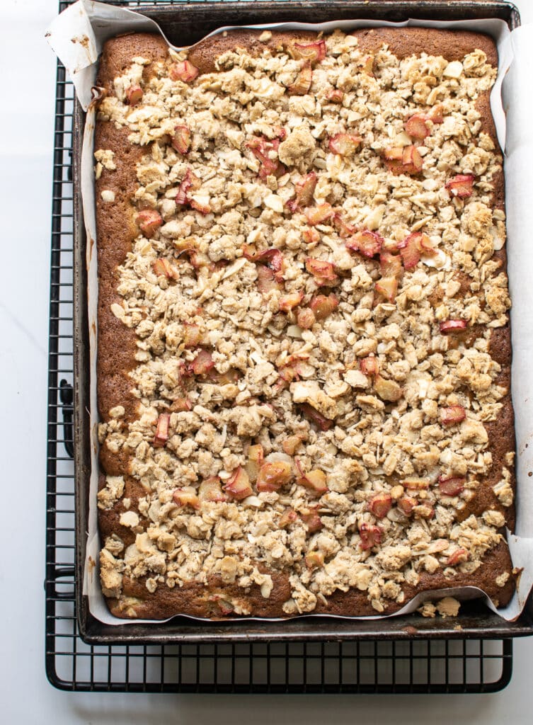 Freshly baked rhubarb cake with an almond crumb topping in a 9 x 13 inch cake pan.