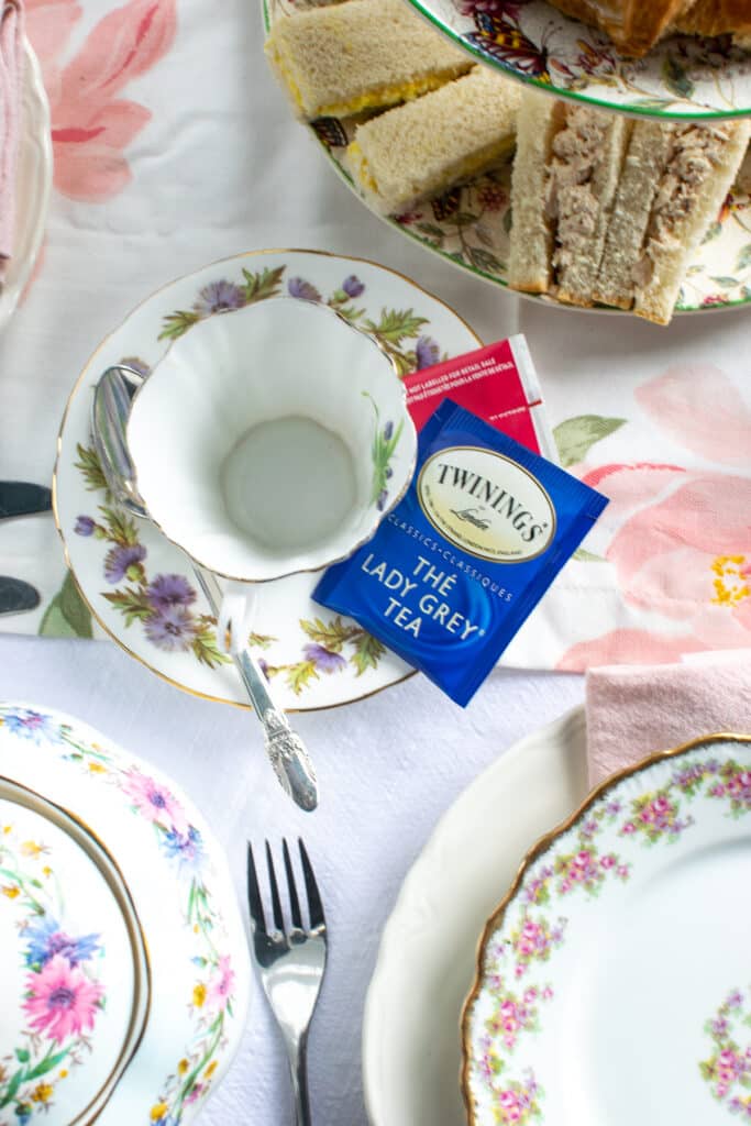 An overhead view of an empty tea cup with a package of Twinnings Lady Grey tea on the saucer.