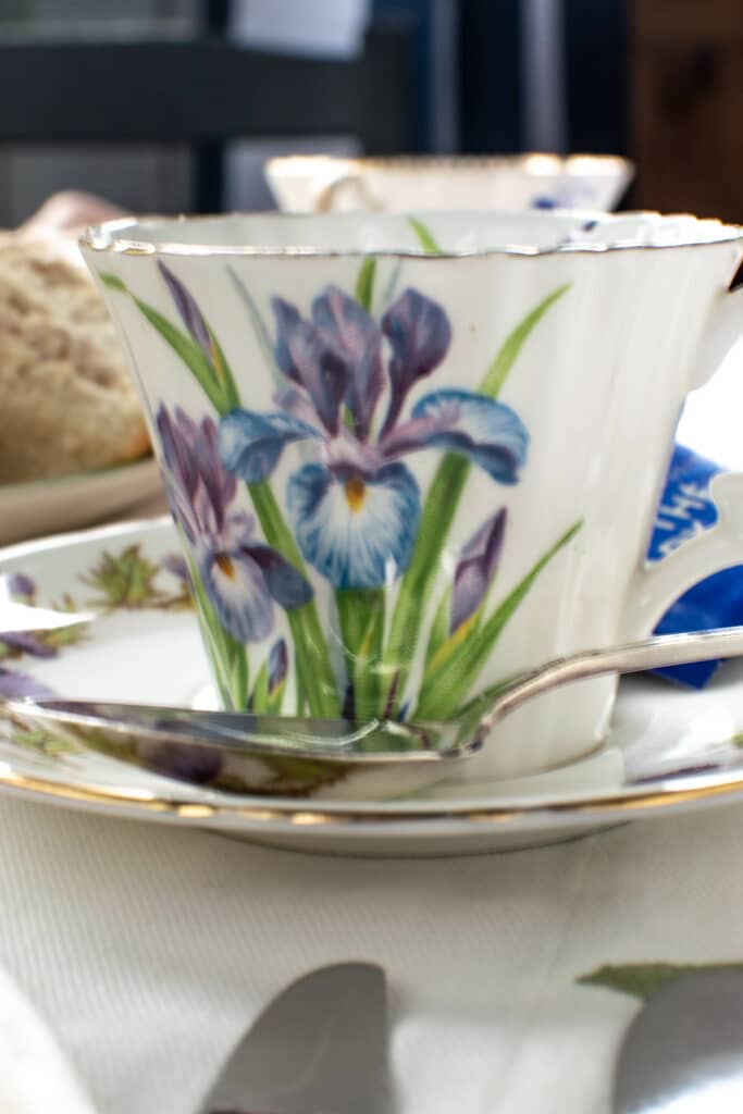 A tea cup with a purple iris pattern.