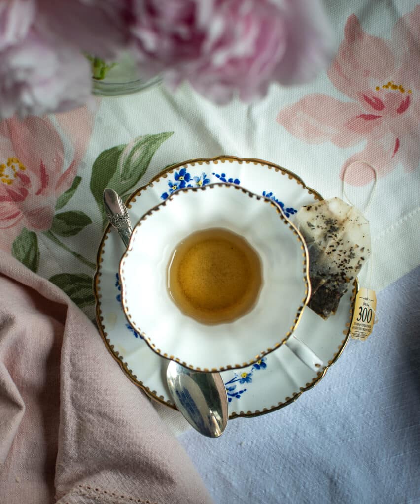 An overhead view of an almost empty cup of tea concludes a list of Afternoon tea party ideas.
