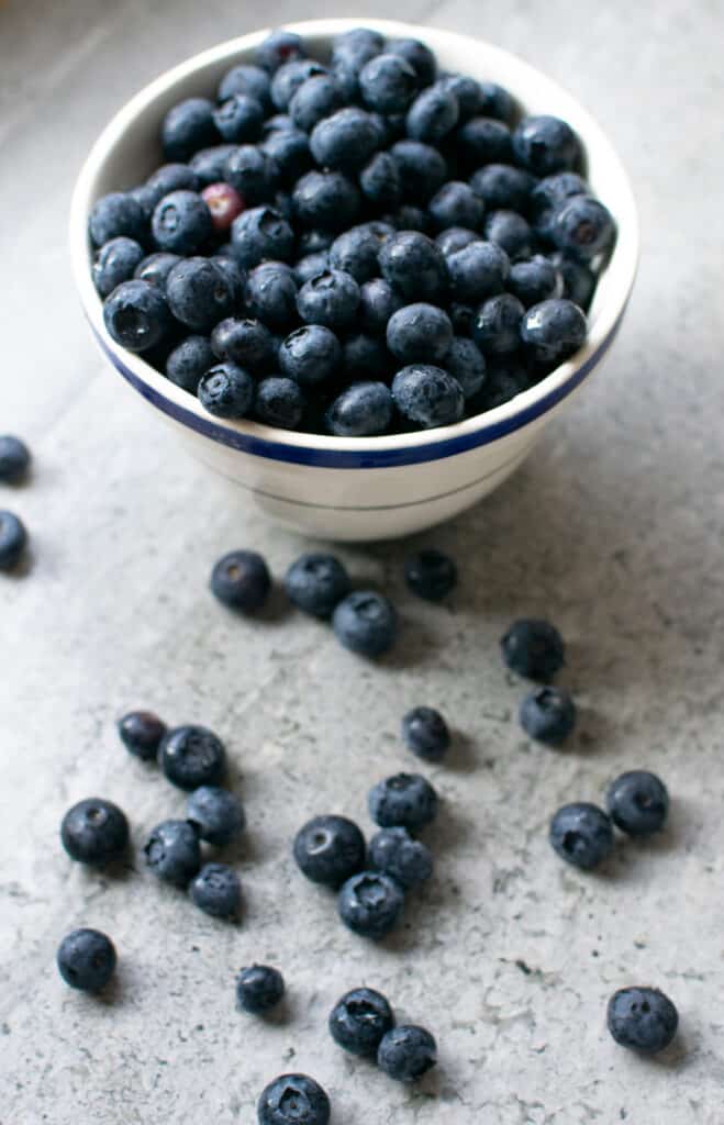 A bowl overflowing with fresh blueberries