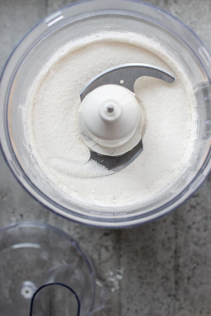 Sugar, flour and baking powder combined in a food processor.