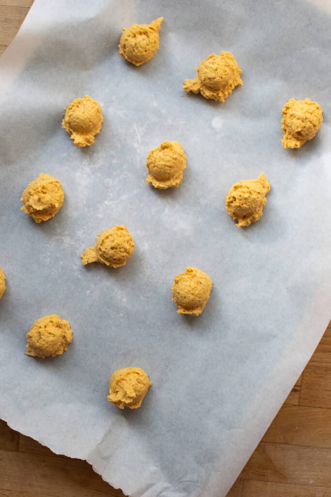 Step by step photos of how to make pumpkin cheesecake thumbprint cookies.