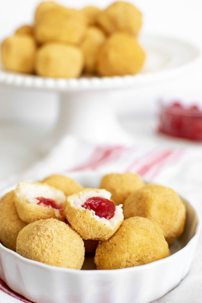 Ball shaped cookies cut in half to expose the cherry in the centre.