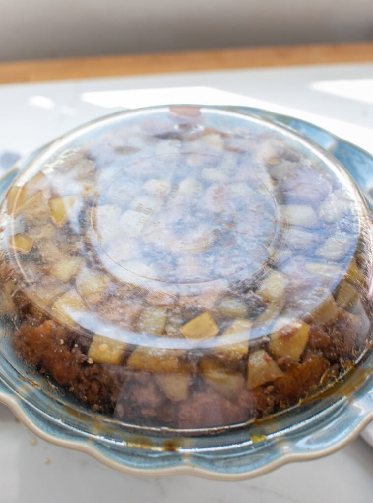 Final 3 steps to making an upside down apple cake including spreading over top of apples, baking, and turning out of pie plate to make it upside down.