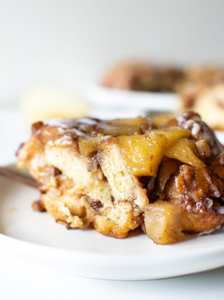 A slice of upside down cinnamon cake on a white plate.