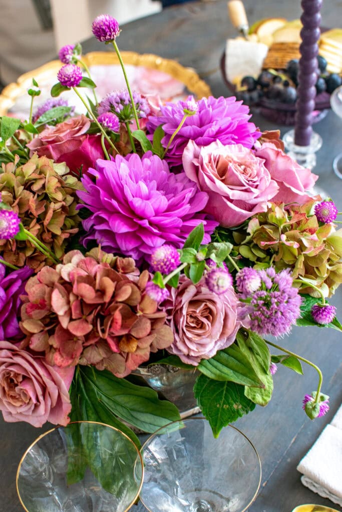 A centrepiece for a dinner table in different shades of purple.