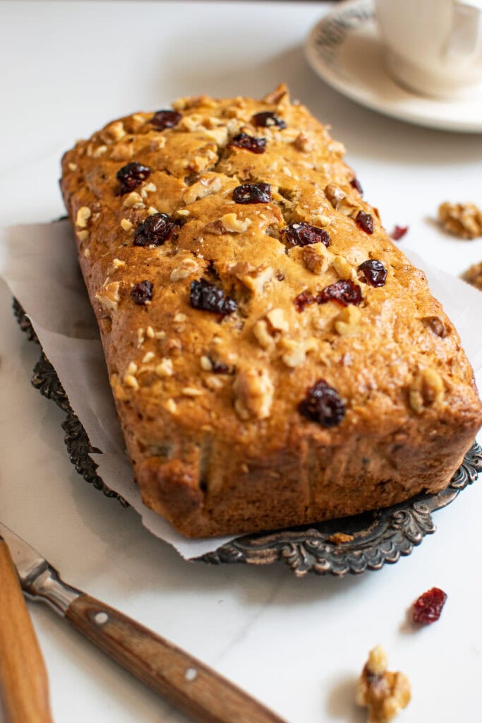 A loaf of banana cranberry nut quick bread fresh out of the oven.