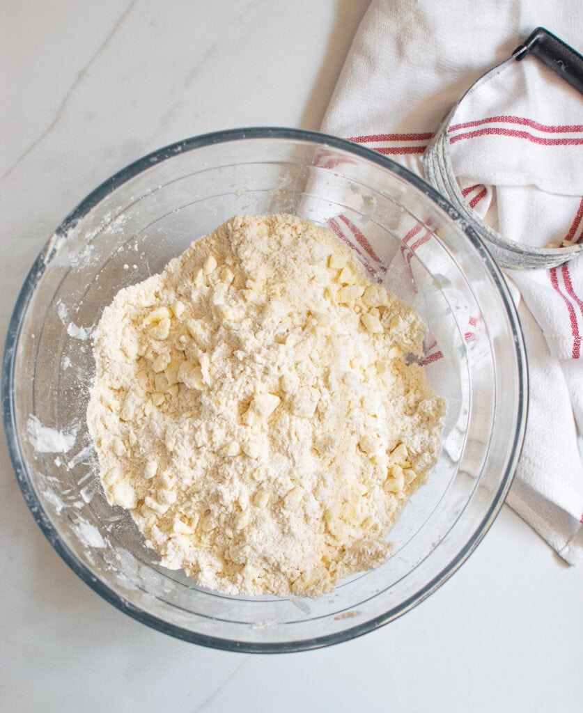 An overhead view of the crumbly mixture of butter and flour for pie pastry