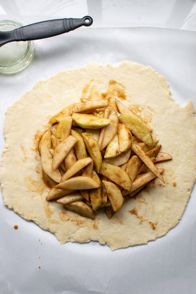 Overhead view of apple and pear filling in the centre of pastry dough.