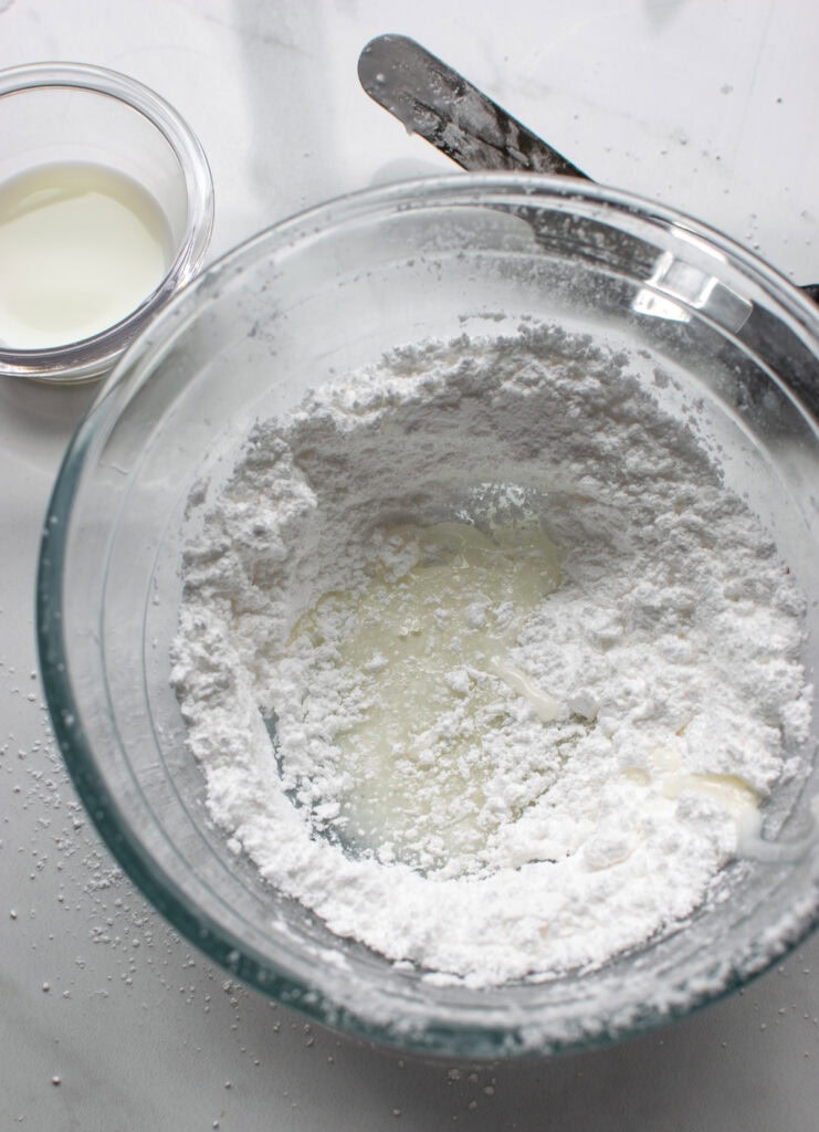 Milk added to sifted confectioners sugar before mixing.