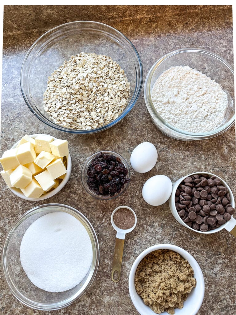 Overhead view of ingredients to make oatmeal cookies with raisins and chocolate chips.