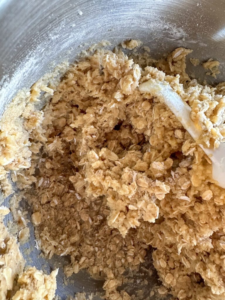 Oatmeal Cookie dough in the bowl of a stand mixer.