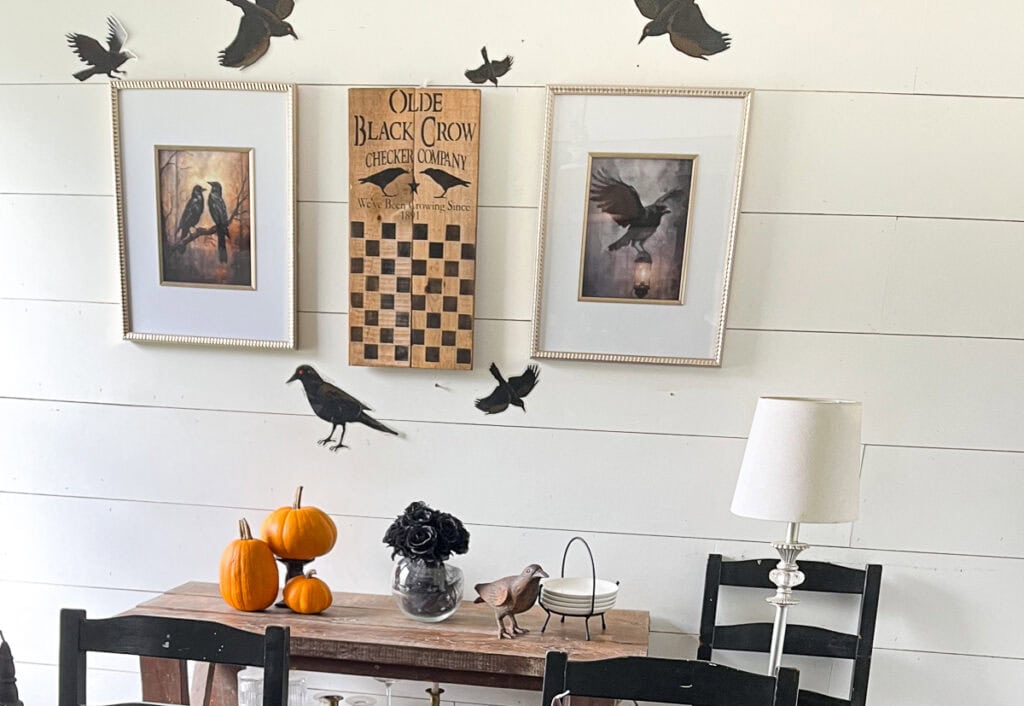 Pictures of crows hang on the wall alongside a crow themed checker board game.