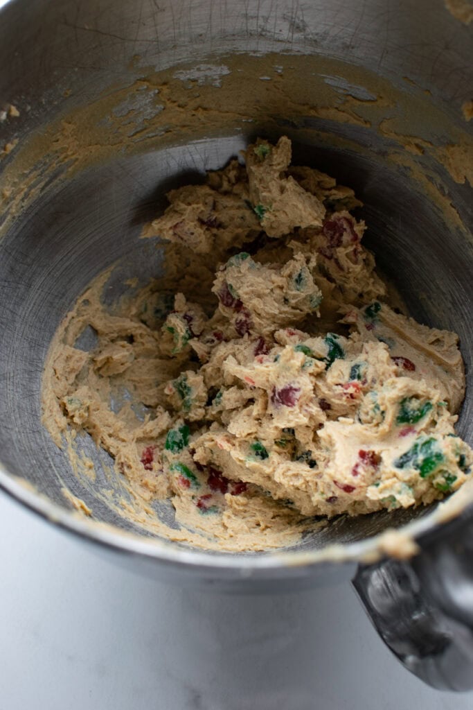 Cherry drop cookie batter in the bowl of electric mixer.