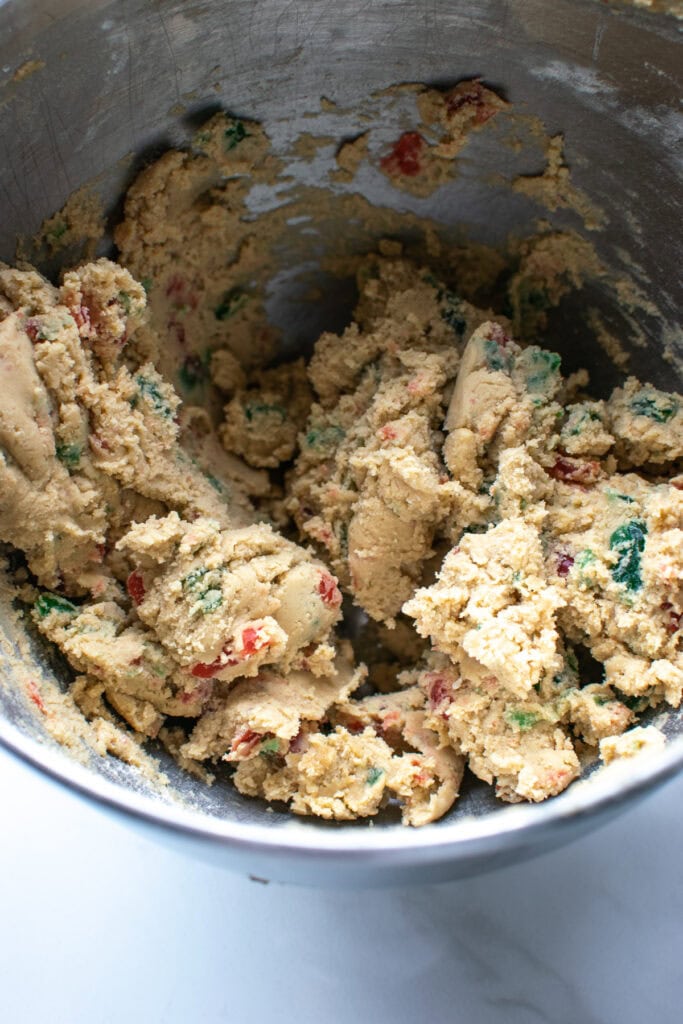 Cherry cookie dough batter with green and red candied cherries.