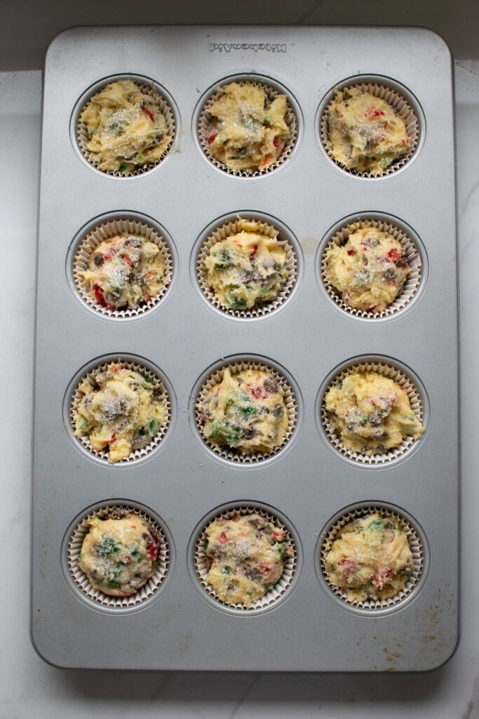 Chocolate Chip and cherry muffin batter in the muffin tins waiting to be baked.