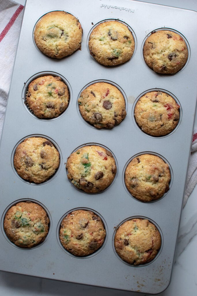 Overhead view of a tray of 12 freshly baked Cherry chocolate chip muffins.