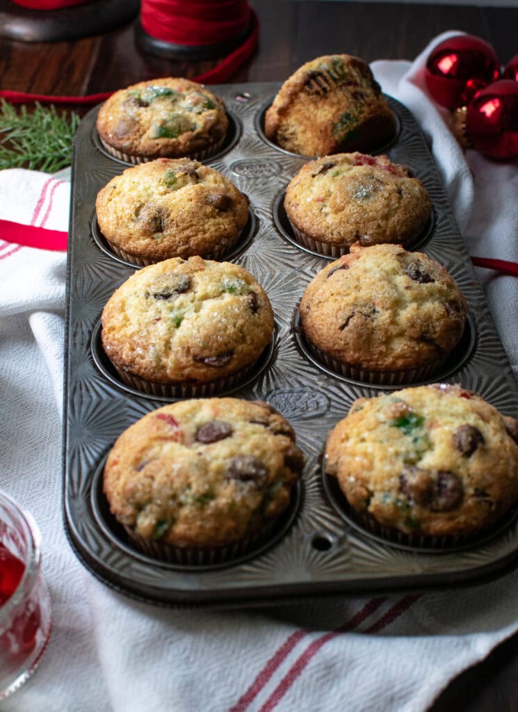 8 chocolate chip cherry muffins on a white and red napkin.