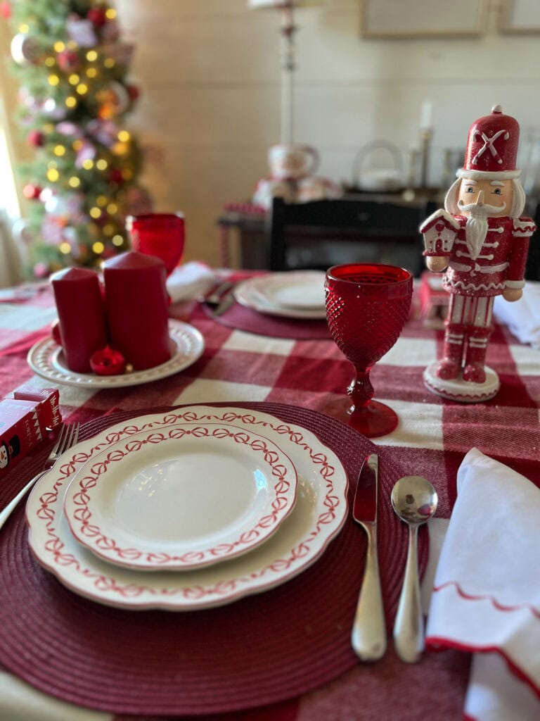 Red round candles on a white plate.