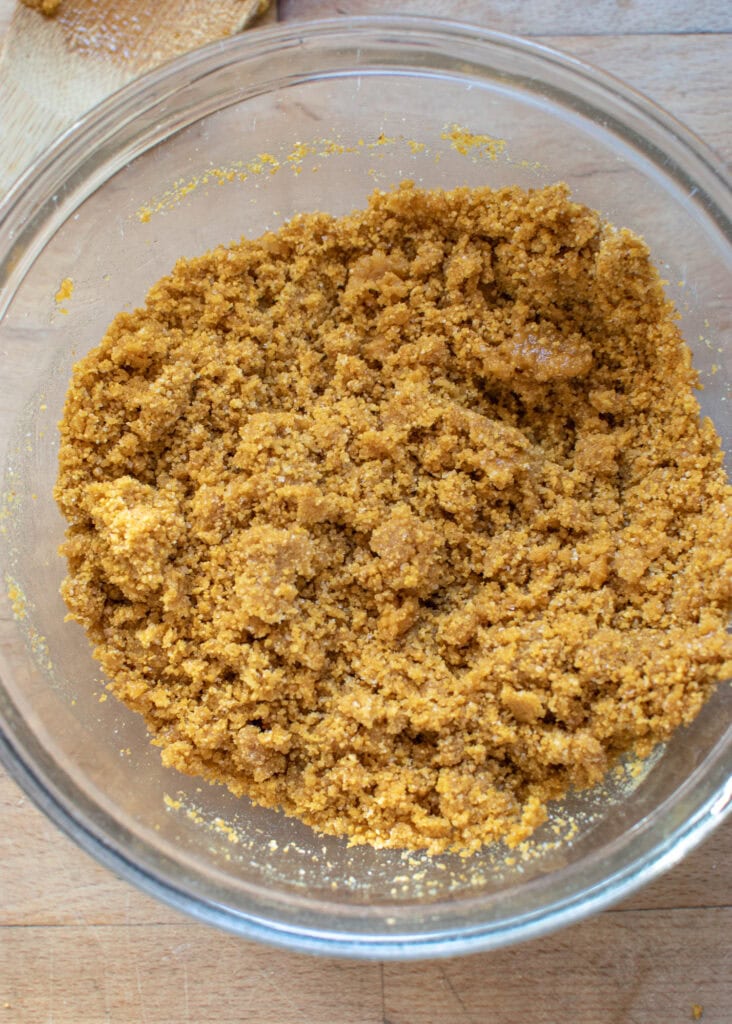 Graham cracker crumb crust ingredients mixed together in a mixing bowl.