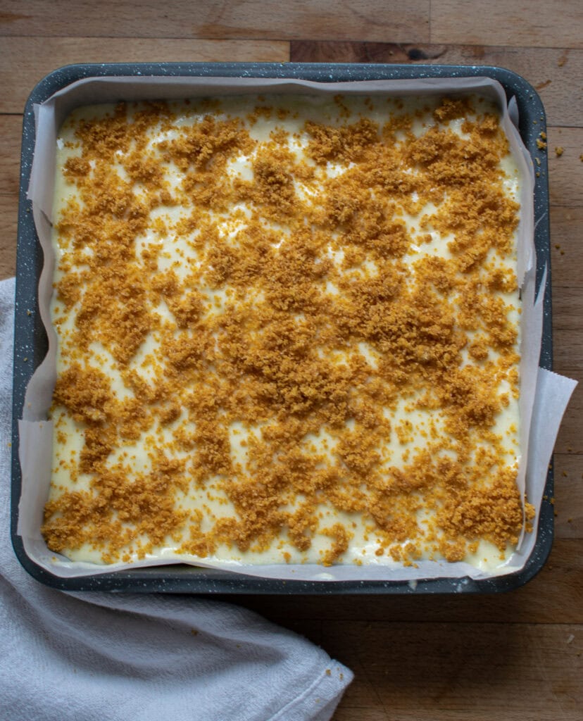 Graham cracker crumbs sprinkled over top of lemon filling ready to go into the oven.