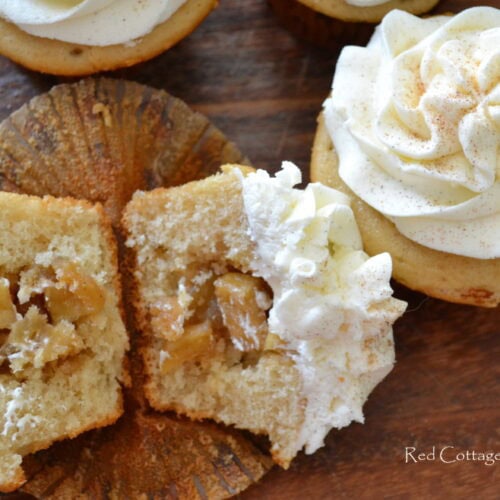 An apple pie cupcake sliced in half to expose the filling.