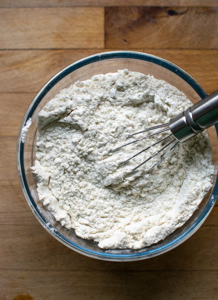 Dry ingredients for banana rum bread whisked together in a bowl.