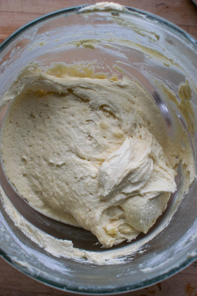 Cake batter in the bowl of a Kitchen Aid stand mixer.