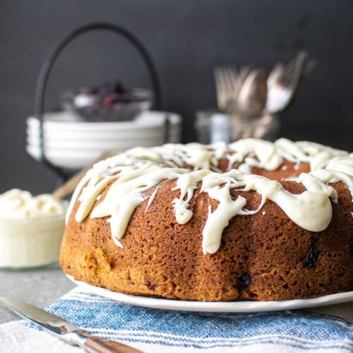 Blueberry coffee cake with a cream cheese glaze drizzled over top.