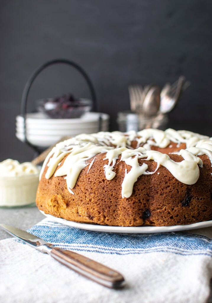 Blueberry coffee cake with a cream cheese glaze drizzled over top.