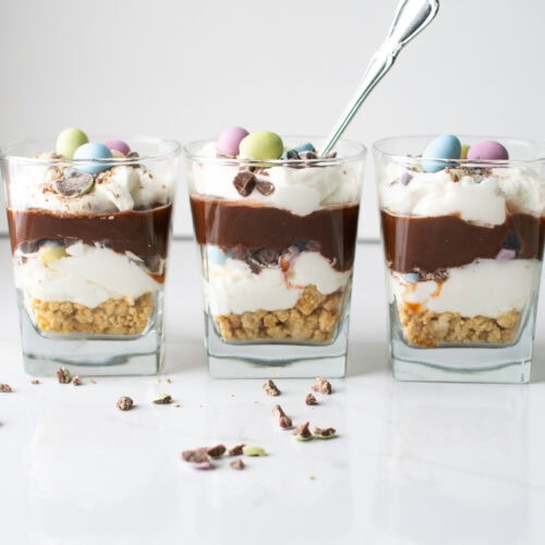 Three Easter chocolate parfaits, with the one in the middle having a spoon in it.