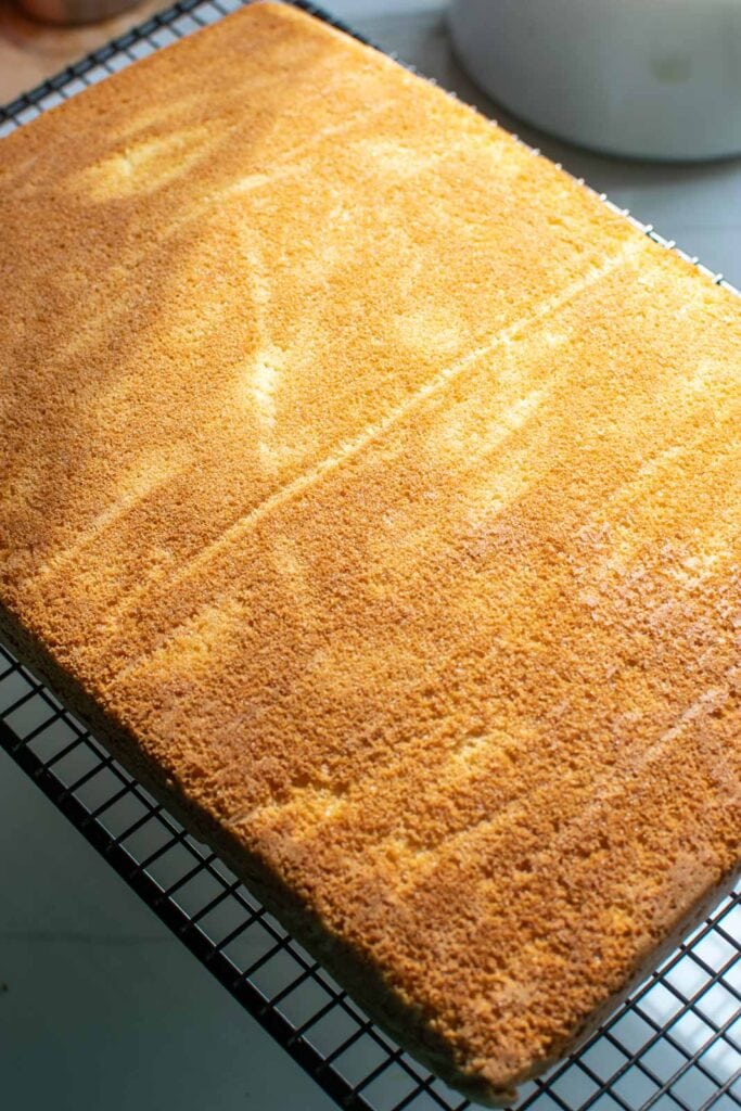 Sheet cake turned out of the pan onto a cooling rack to cool before frosting.